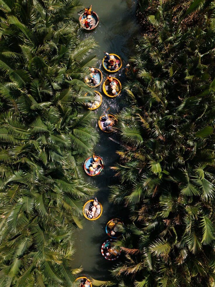 Boatmen performing folk dance on basket boat Hoi An